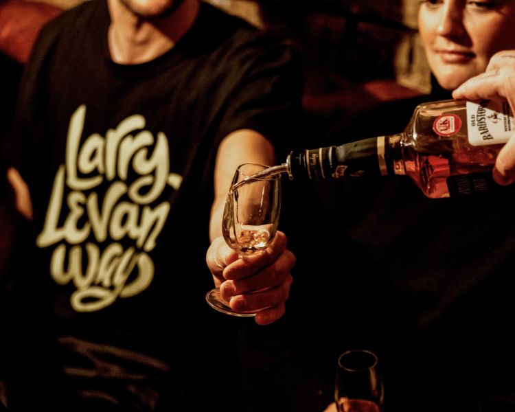 whisky being poured into a glass for a tasting experience in london