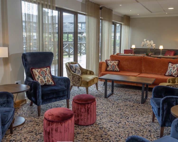 the lobby and reception area with comfy seating at q hotels basingstoke