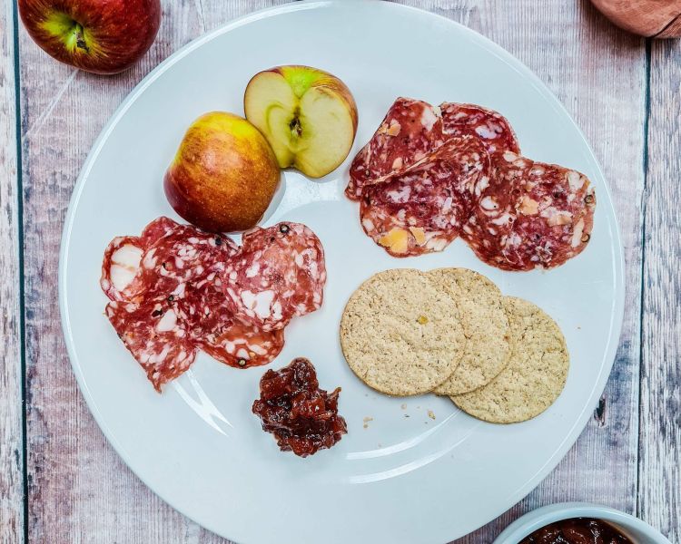 plate of charcuterie with apple, chutney and crackers made on a charcuterie making course with bray cured