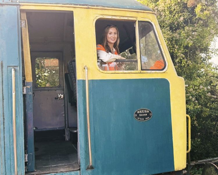 woman sitting in train driver carriage and looking out the window